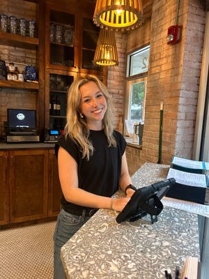 A teenage host at Table 301 a restaurant in Greenville, South Carolina.