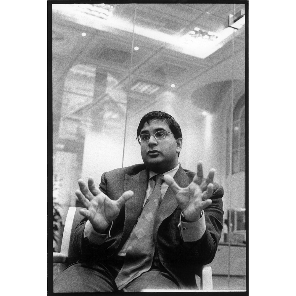 Avinash Persaud, wearing a dark suit and tie, gestures as he speaks during his time as an analyst with State Street Company in London in 2001.