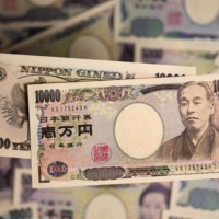 The yen's recent weakening may not be as rapid as last year, but it will likely stay weak longer, analysts say. | BLOOMBERG