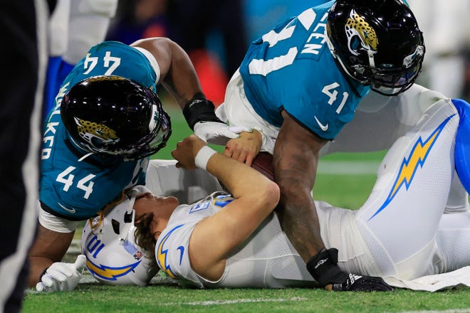 Jacksonville Jaguars linebacker Travon Walker (44) and linebacker Josh Allen (41) combine to sack Los Angeles Chargers quarterback Justin Herbert (10) during the second quarter of an NFL first round playoff football matchup Saturday, Jan. 14, 2023 at TIAA Bank Field in Jacksonville, Fla. The Jacksonville Jaguars edged the Los Angeles Chargers on a field goal 31-30. [Corey Perrine/Florida Times-Union]