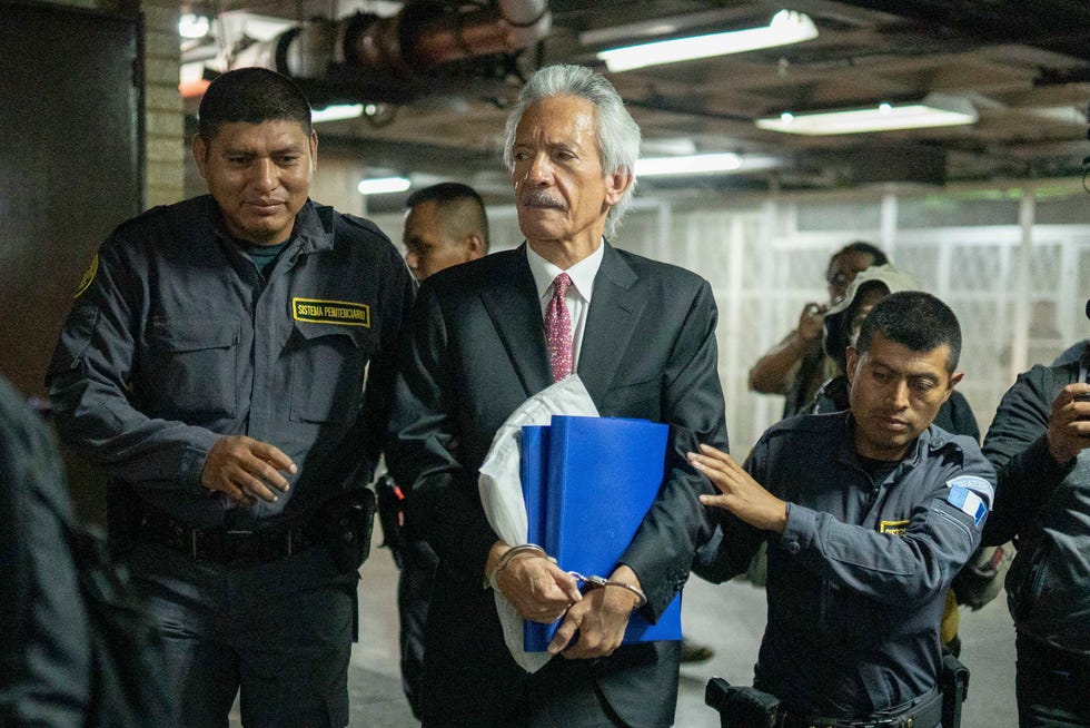 Newspaper founder and editor Jose Ruben Zamora is escorted by police before a hearing at a court in Guatemala City, Wednesday, June 14, 2023. A tribunal has convicted Zamora and sentenced him to six years in prison in a money laundering case.
