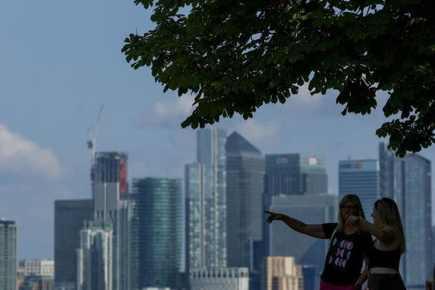 FILE PHOTO: People look out from Greenwich Park, with Canary Wharf in the distance, in London, Britain June 22, 2023. REUTERS/Hannah McKay/File Photo
