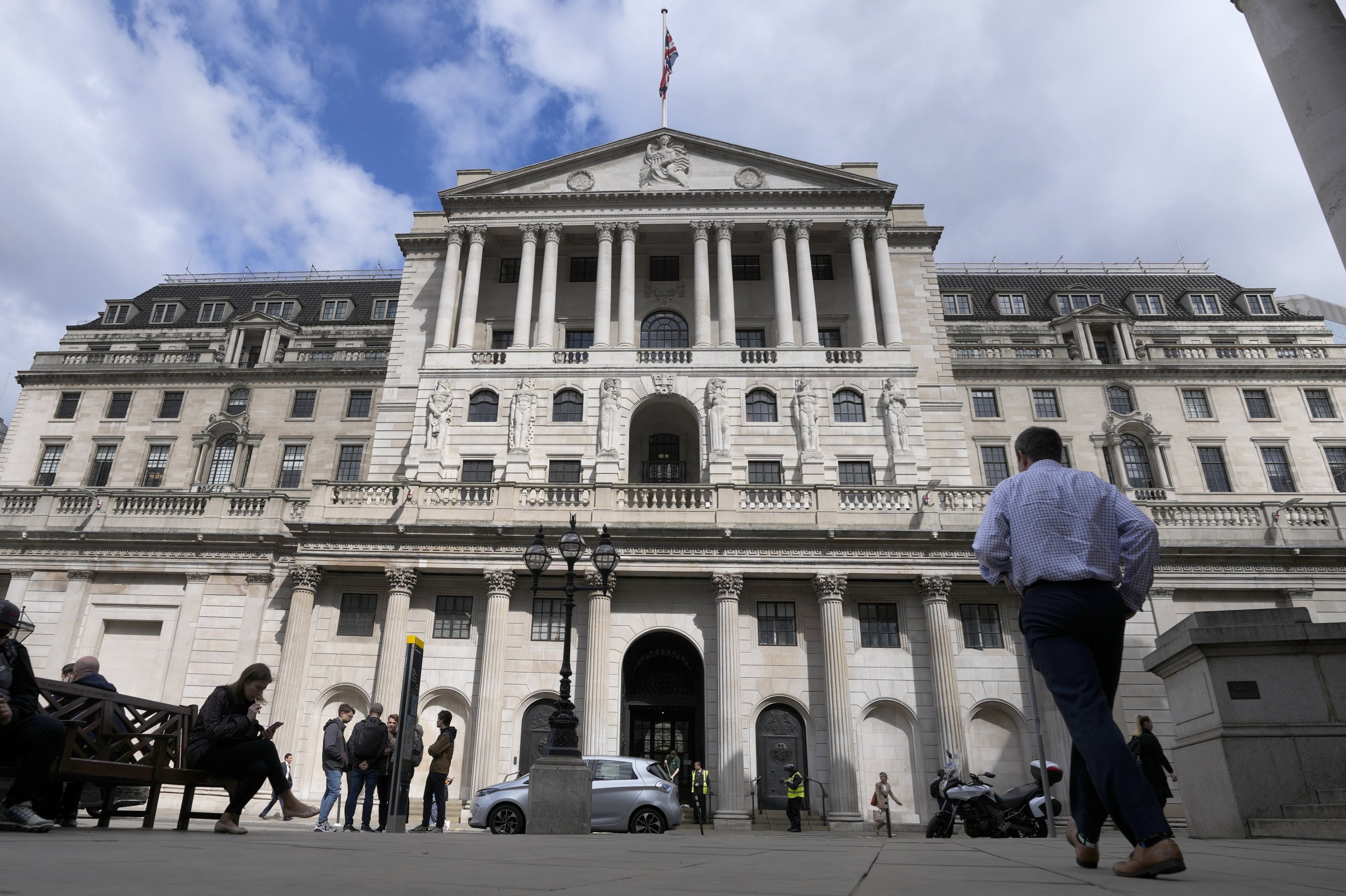 People walk past the Bank of England in London, U.K., May 5, 2022 (AP)