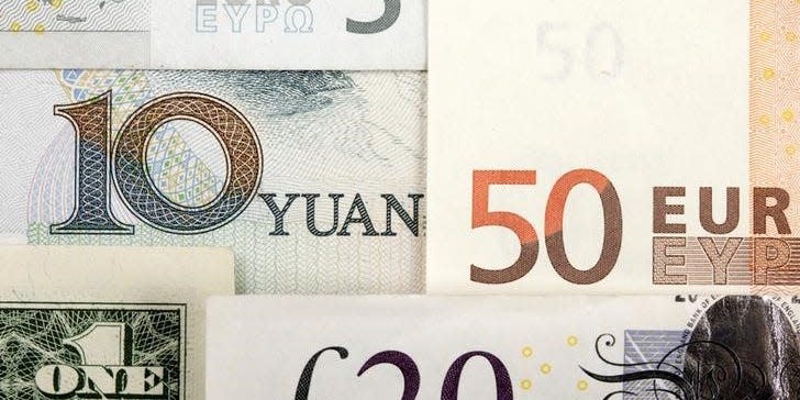 Arrangement of various world currencies including Chinese Yuan, US Dollar, Euro, British Pound, in this picture illustration taken January 25, 2011.  REUTERS/Kacper Pempel/Illustration/File Photo