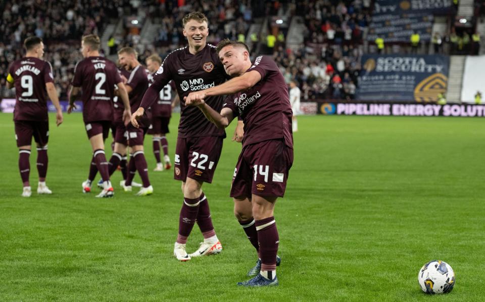 Denholm celebrates with Cammy Devlin, the hero of the match against the Norwegians and his sidekick in midfield. (Photo: Paul Devlin - SNS Group)