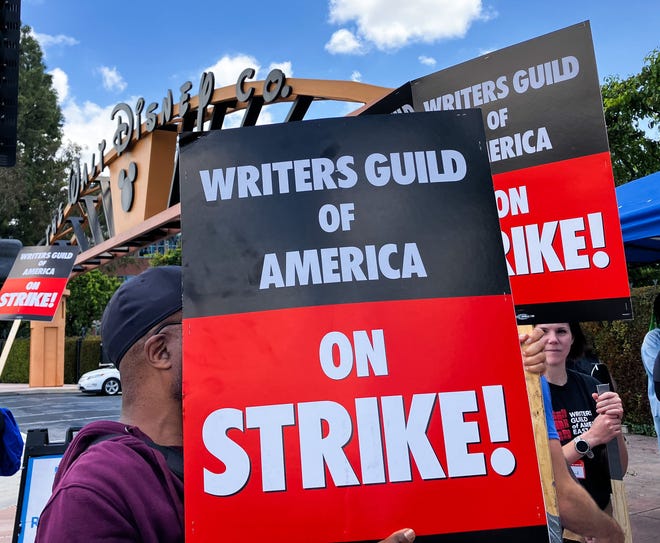 Members of the Writers Guild of America picket in front of Disney Studios. The WGA is the union representing most writers for film and TV in the U.S., strike in Los Angeles. The strike comes after weeks of negotiations failed to generate a contract between the guild and the Alliance of Motion Picture and Television Producers (AMPTP), which bargains on behalf of the nine largest studios.