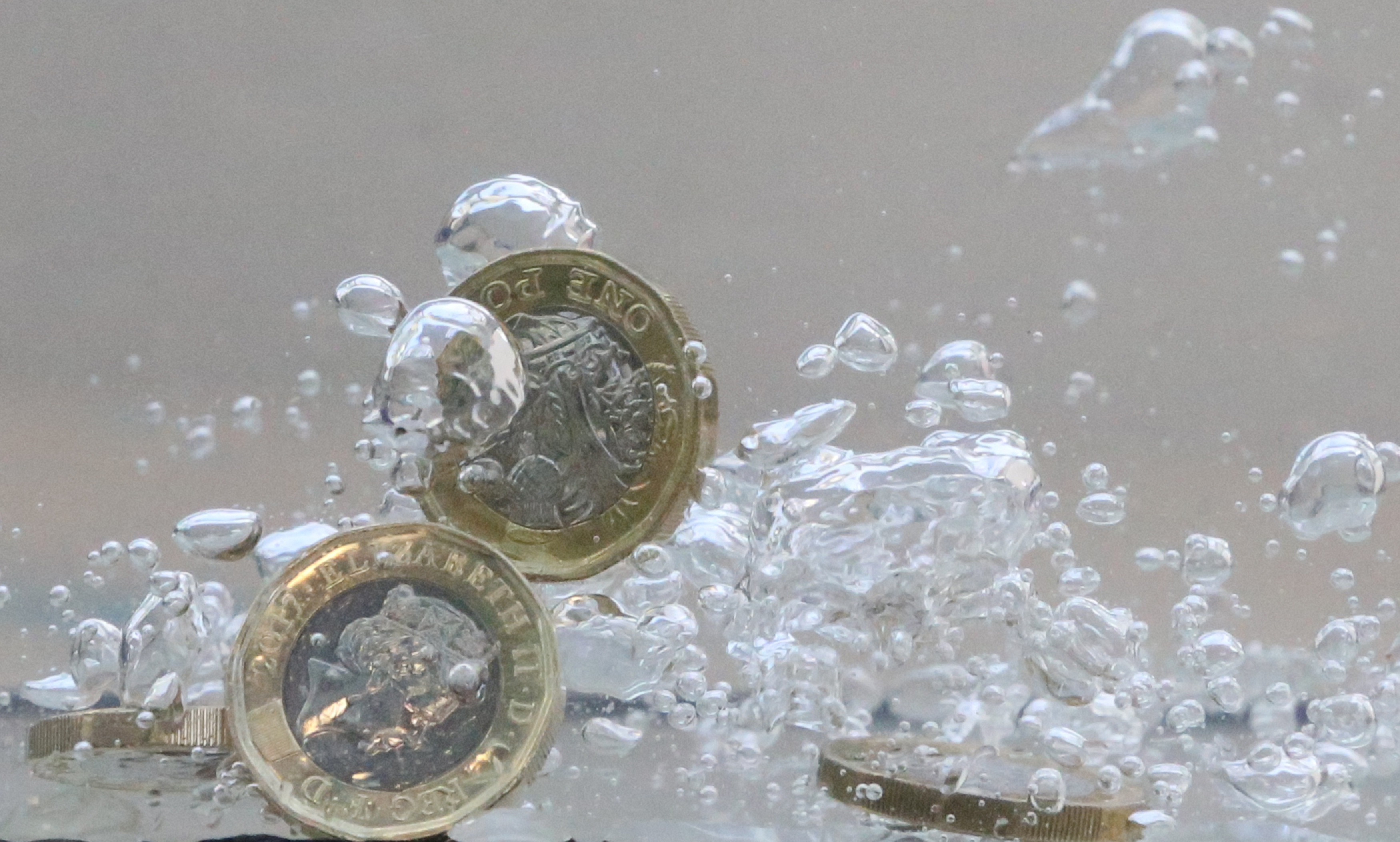 UK pound coins plunge into water in this illustration picture