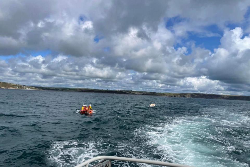 Little Haven inshore lifeboat tows the capsized dinghy back to Solva harbour. <i>(Image: St  Davids RNLI)</i>