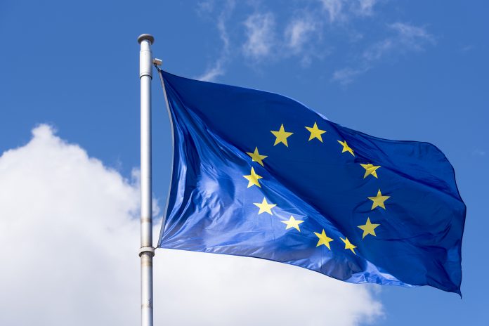 EU Flag waving against blue Sky, horison europe funding