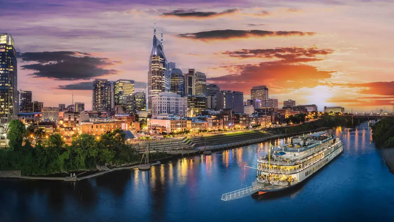 Nashville skyline with river and sunset.