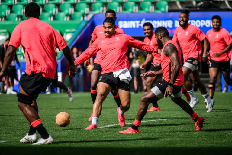 Fiji hooker Sam Matavesi (centre) and his teammates play football to warm-up during a training session ahead of their World Cup clash with Australia (JEFF PACHOUD)