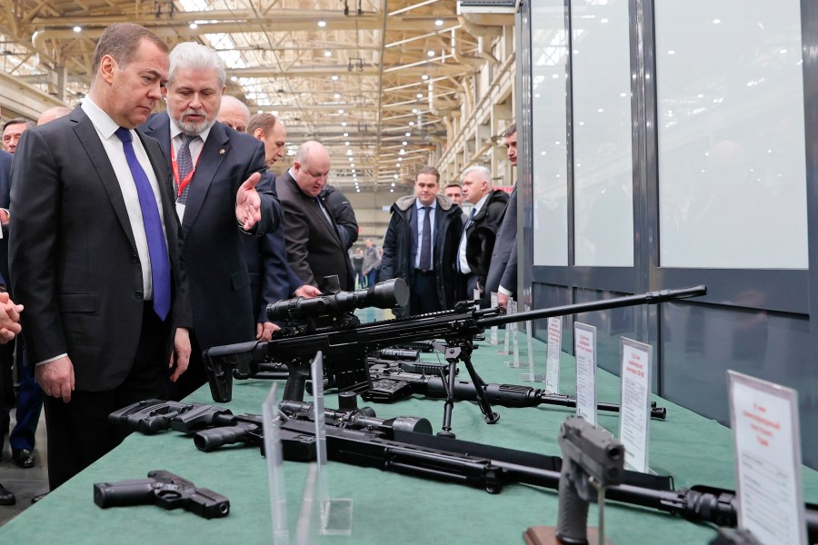 FILE - Deputy head of Russia's Security Council and chairman of the United Russia party Dmitry Medvedev, left, listens to General Director of the Kalashnikov Concern Vladimir Lepin, second left, while visiting the Kalashnikov Group plant in Izhevsk, Russia, Tuesday, Jan. 24, 2023. The United States on Thursday, Sept. 14, 2023, is sanctioning more than 150 businesses and people from Russia to Turkey, the United Arab Emirates and Georgia to try to crack down on evasion and deny the Kremlin access to technology, money and financial channels that fuel President Vladimir Putin’s war in Ukraine. (Ekaterina Shtukina, Sputnik Pool Photo via AP, File)