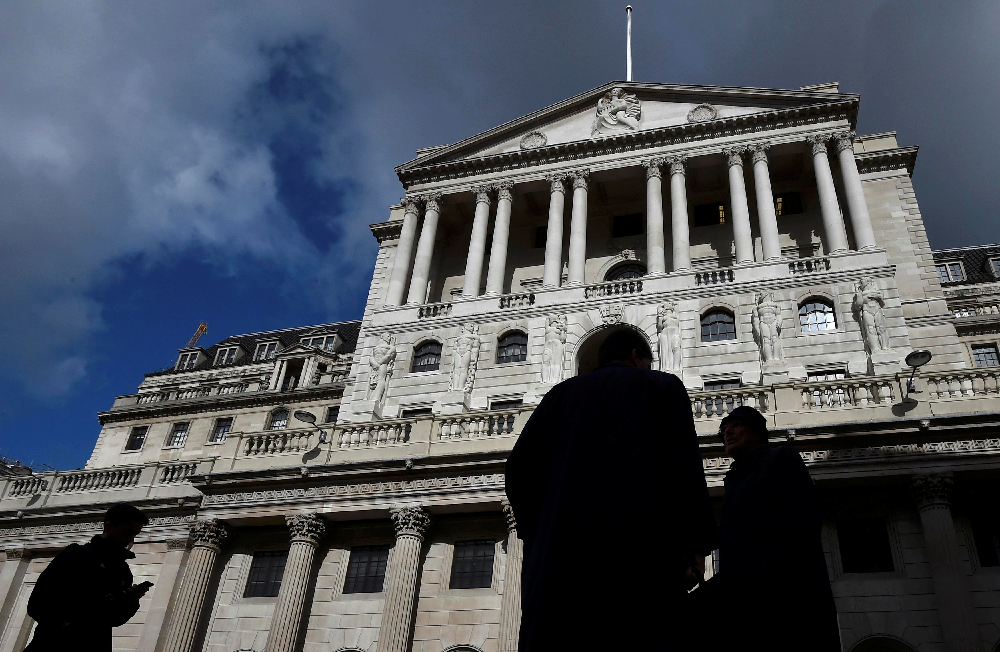 File photo of city workers walking past the Bank of England in the City of London