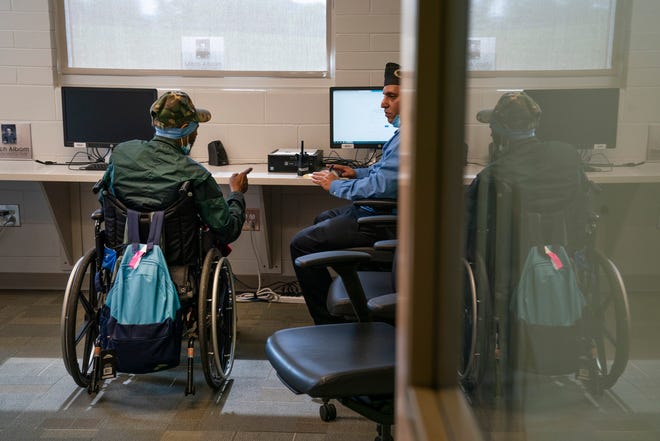 Army Ranger veteran John Bennett, 68, of Detroit, now temporarily homeless, left, gets help from Homeless management information system employee with Michigan Veterans Foundation, Saad Shouman, to create an email account on Tuesday, Aug. 29, 2023, in Detroit. Staff at the Michigan Veterans Foundation in Detroit work year-round to make life better for veterans who rely on their services.