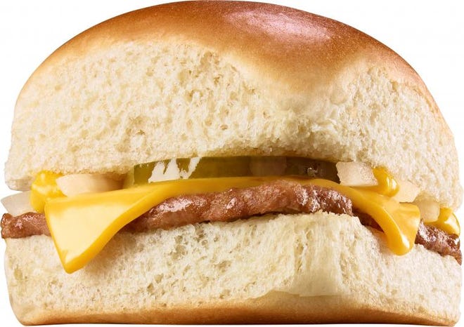 A Cheese Krystal, made with onions, a slice of American cheese, mustard and a dill pickle on Krystal’s signature steamed bun.