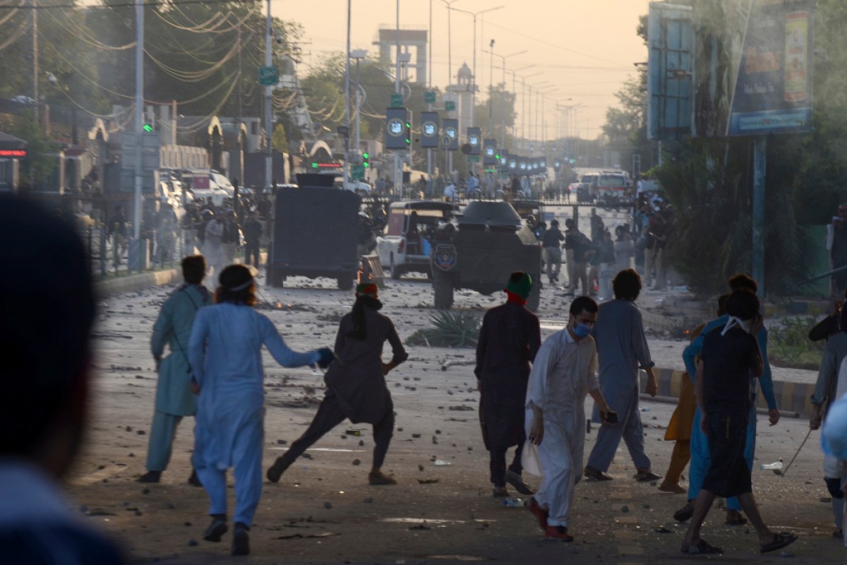 PESHAWAR, PAKISTAN, MAY, 09: Police fire tear gas to disperse supporters of Pakistan's former Prime Minister Imran Khan protesting against the arrest of their leader, in Peshawar, Pakistan, Tuesday, May 9, 2023. Khan was arrested and dragged from court as he appeared there to face charges in multiple graft cases, a dramatic escalation of political tensions that sparked violent demonstrations by his supporters in major cities. (Photo by Hussain Ali/Pacific Press/Sipa USA)(Sipa via AP Images)