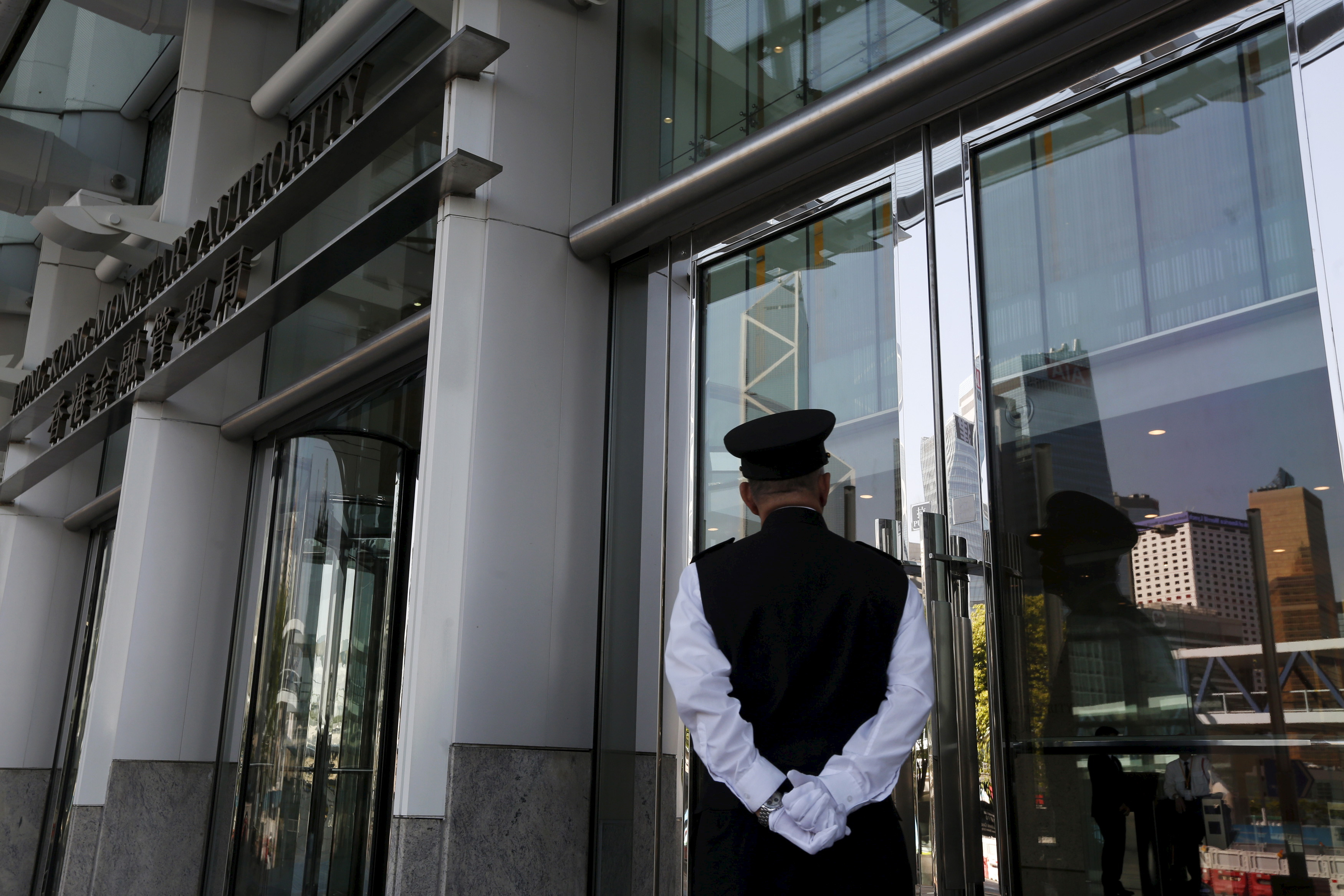 A guard stands in front of the entrance to the Hong Kong Monetary Authority in Hong Kong