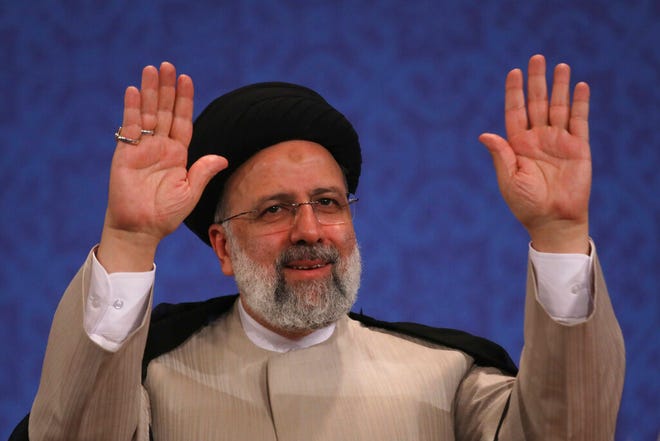 Iran's new President-elect Ebrahim Raisi waves to participants at the conclusion of his press conference in Tehran, Iran, on June 21, 2021. Raisi said Monday he wouldn't meet with President Joe Biden nor negotiate over Tehran's ballistic missile program and its support of regional militias, sticking to a hard-line position following his landslide victory in last week's election.