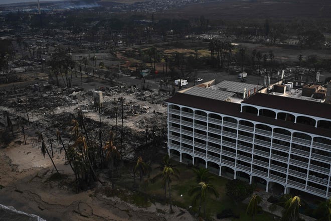 An aerial image shows the Lahaina Shores Beach Resort standing alone besides destroyed homes and buildings burned to the ground in the historic Lahaina Town in the aftermath of wildfires in western Maui in Lahaina, Hawaii, on Aug. 10, 2023.