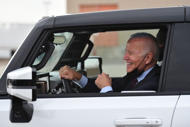 President Joe Biden smiles as he test drives an electric hummer as he tours the General Motors Factory ZERO electric vehicle assembly plant in Detroit, Michigan on November 17, 2021.