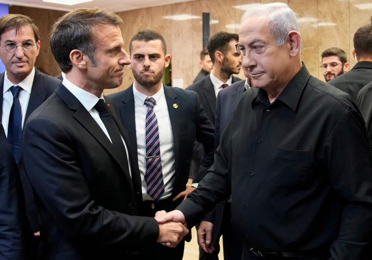 Israeli Prime Minister Benjamin Netanyahu shakes hands with French President Emmanuel Macron after their joint press conference in Jerusalem today.  