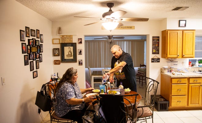 Lehigh Acres residents, Michael and Colleen Barineau eat dinner at their home on Wednesday, Oct. 11, 2023.