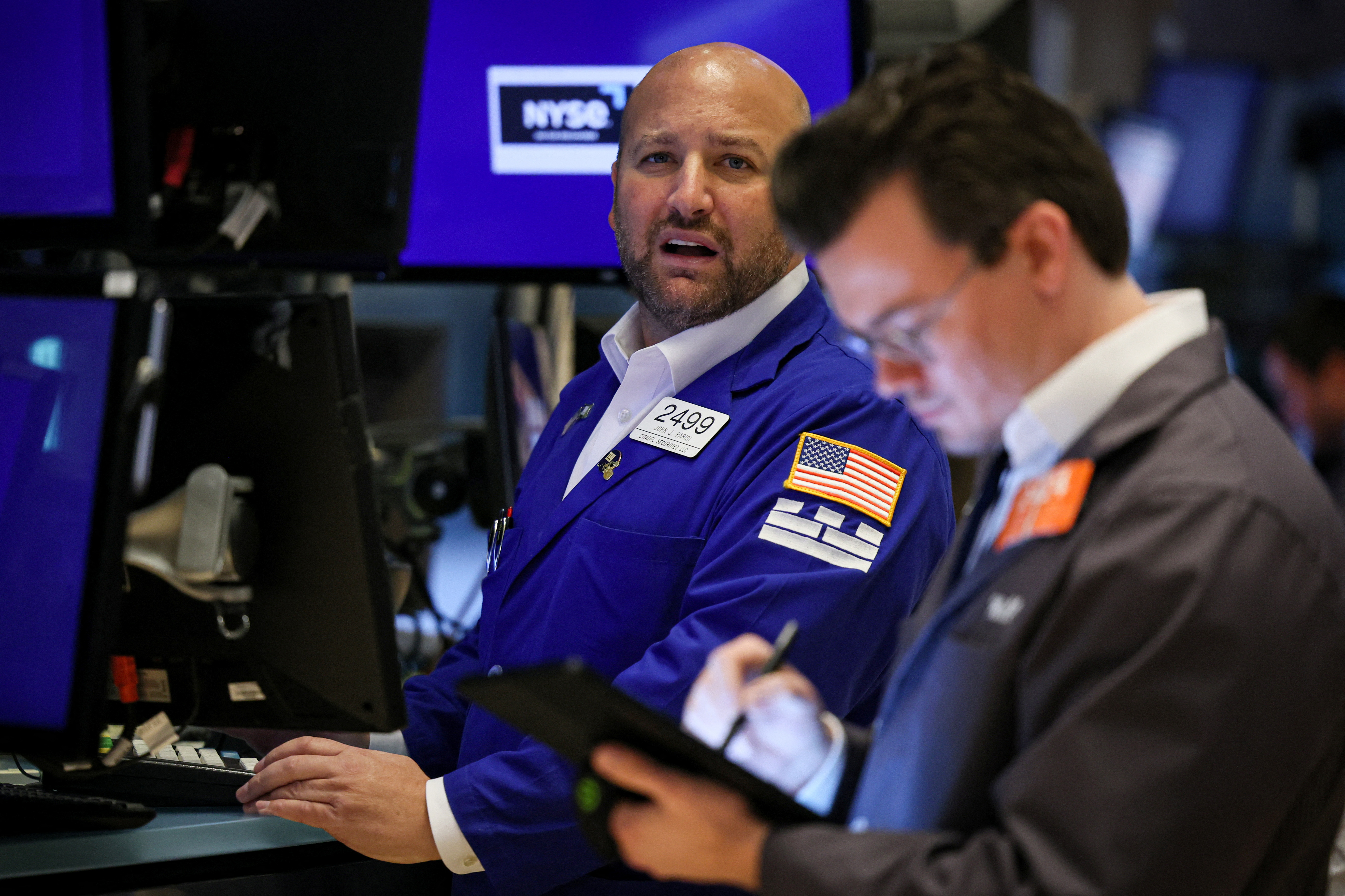 Traders work on the floor of the NYSE in New York