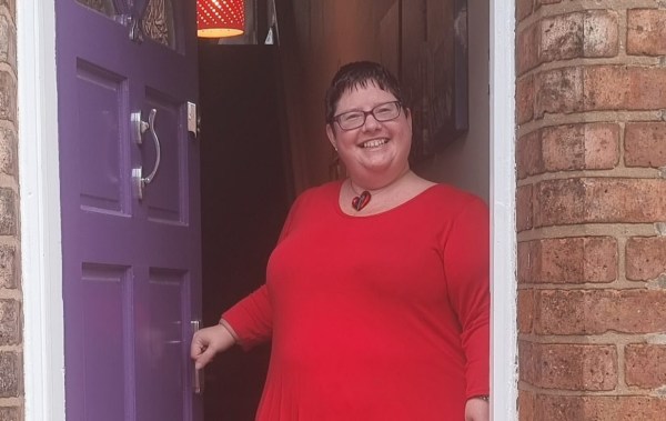 Helen stands in the doorway of her terraced home 