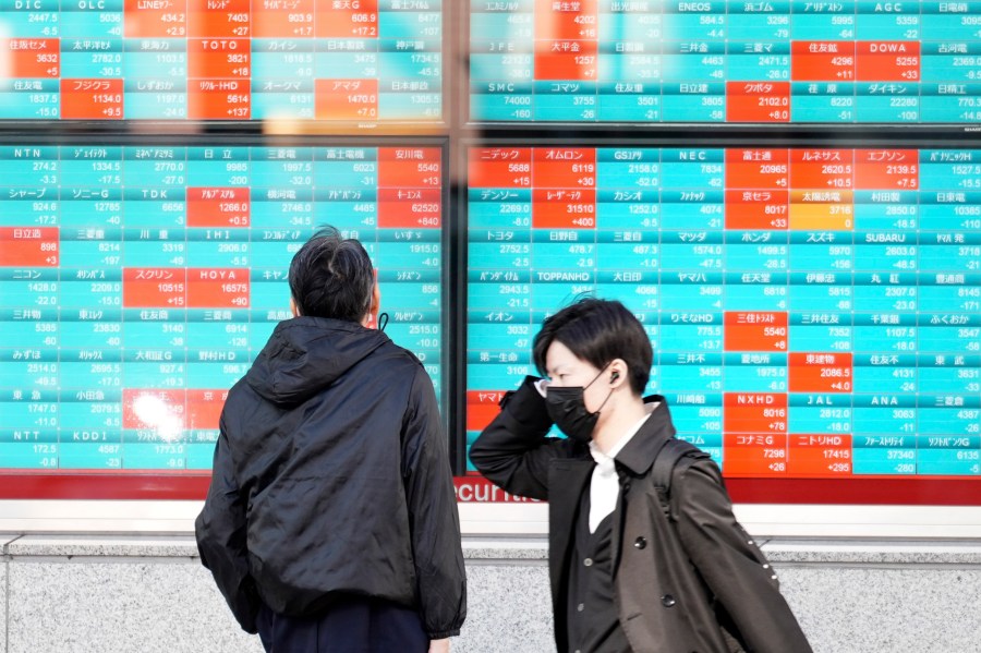 A person looks at an electronic stock board showing Japan's Nikkei 225 index at a securities firm Wednesday, Nov. 29, 2023, in Tokyo. (AP Photo/Eugene Hoshiko)