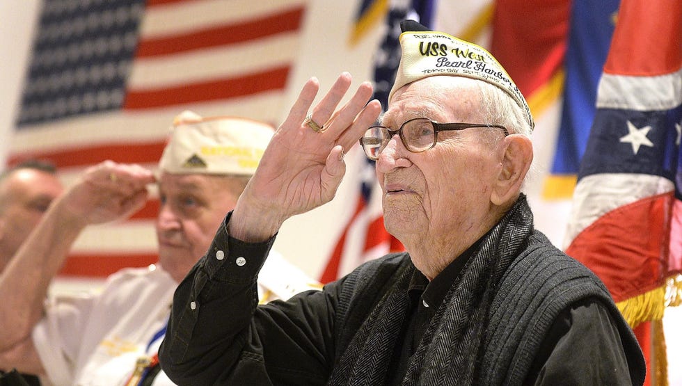Adone "Cal" Calderone, who survived Pearl Harbor aboard the USS West Virginia, salutes the flag during national anthem at a memorial service for veterans at American Legion Post 44 on Dec. 7, 2018, when he was 98. He died at age 100 in 2020.