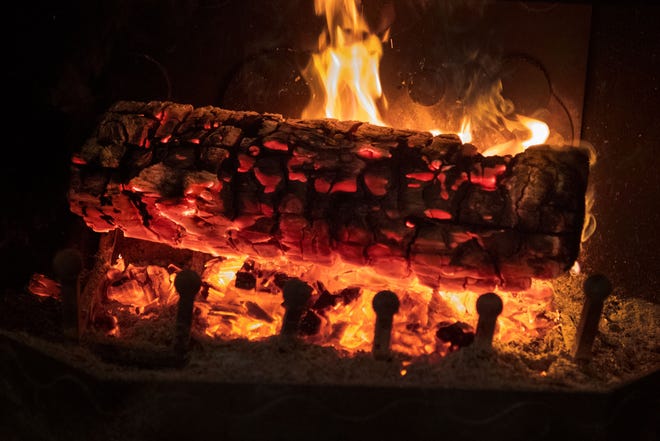 A log burns in a fireplace. (Photo by FRED TANNEAU / AFP) (Photo by FRED TANNEAU/AFP via Getty Images)