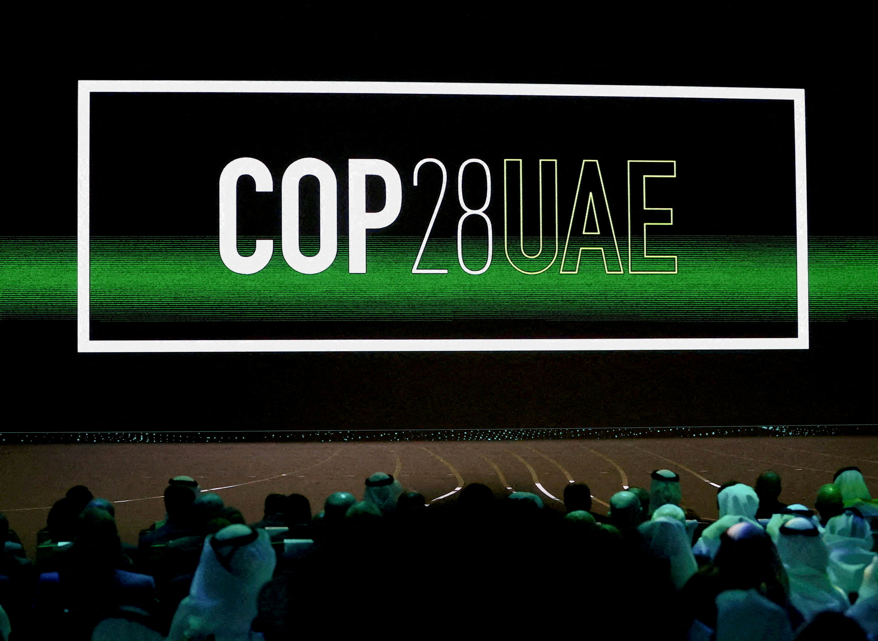 'Cop28 UAE' logo is displayed on the screen during the opening ceremony of Abu Dhabi Sustainability Week (ADSW) under the theme of 'United on Climate Action Toward COP28', in Abu Dhabi