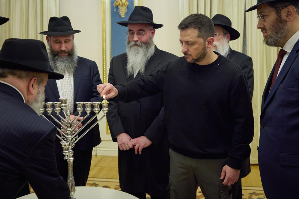 Ukrainian President Volodymyr Zelenskyy marks the first night of the Jewish holiday of Hanukkah by lighting the first candle in Kyiv, Ukraine (AP)