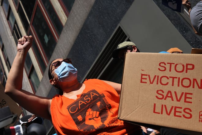 People gather outside of a New York City Marshall's office calling for a stop to evictions in New York City.