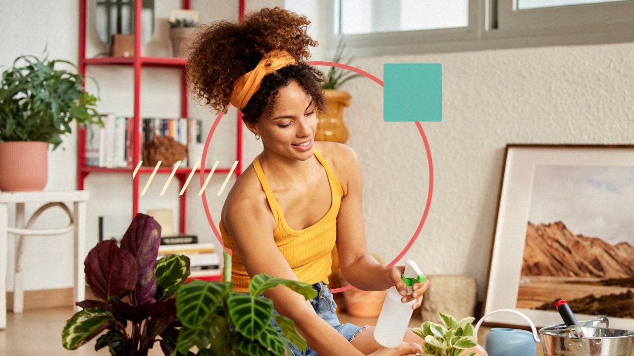 A woman watering plants in there studio