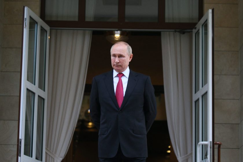 a picture of vladimir putin standing in front of two open doors and curtains