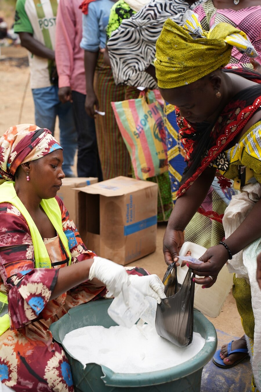 Chrisitina - an internally displaced person, buying food from the local market with the assistance from WFP.