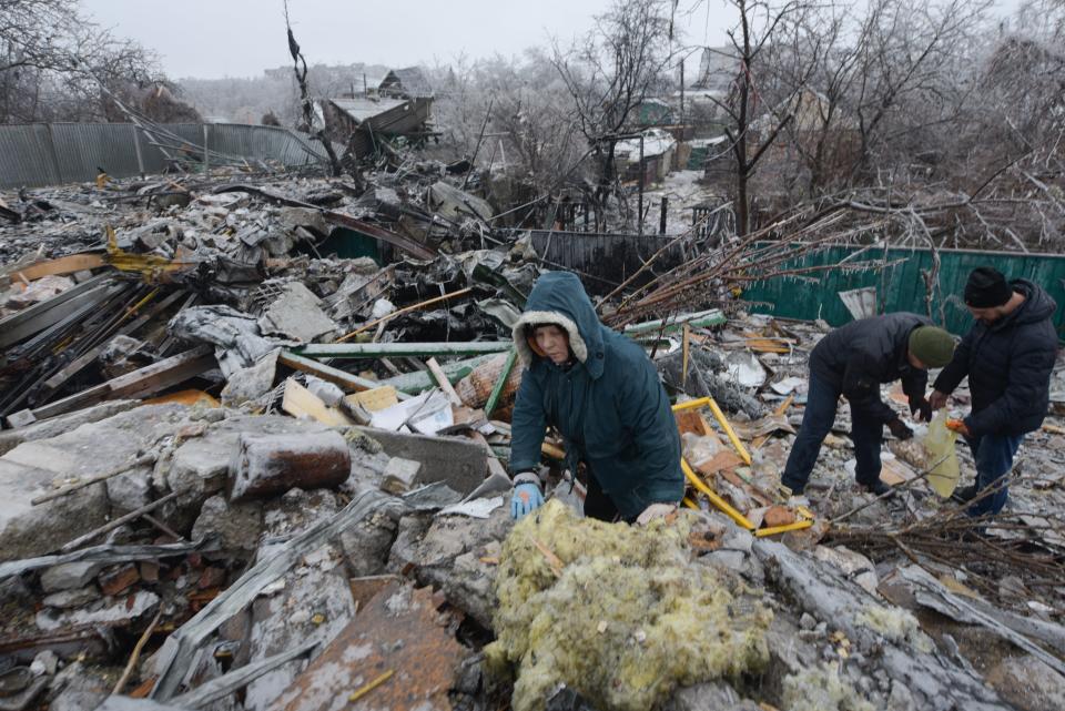 Ukrainians sifting through the rubble (AFP via Getty Images)