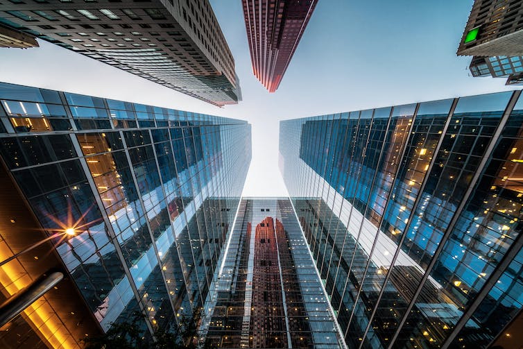 Upward view of city skyscrapers.