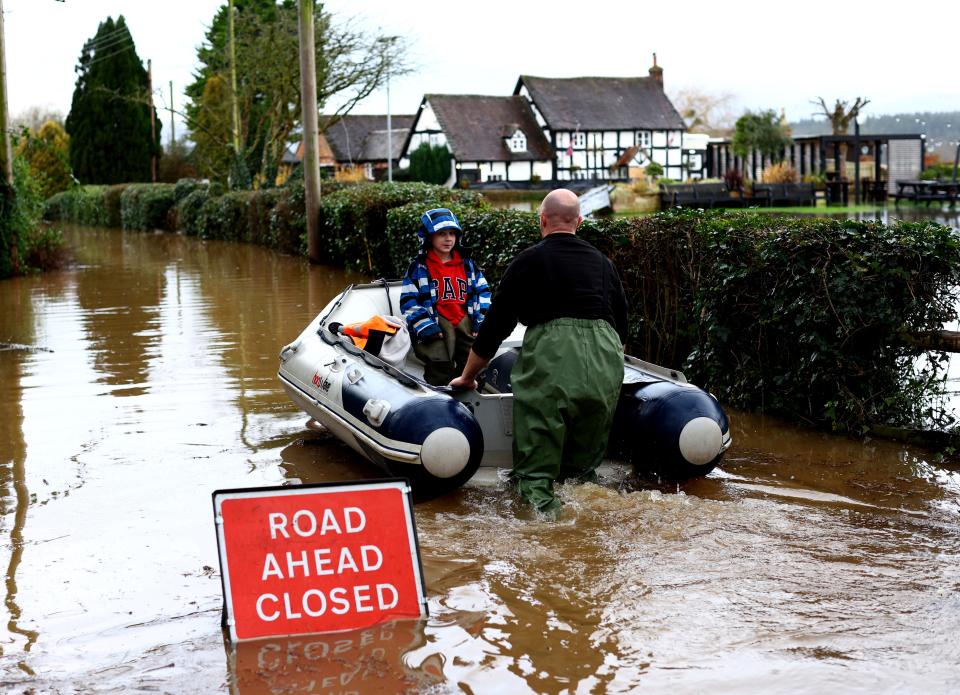 Jack, aged 7, is rescued as the village of Severn Stoke is cut off amid flooding after heavy rain from Storm Henk (REUTERS)