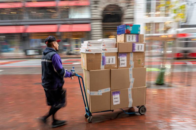 A worker delivers packages in Union Square in San Francisco, California, US, on December 18, 2023 as US retail sales picked up in November. Bloomberg