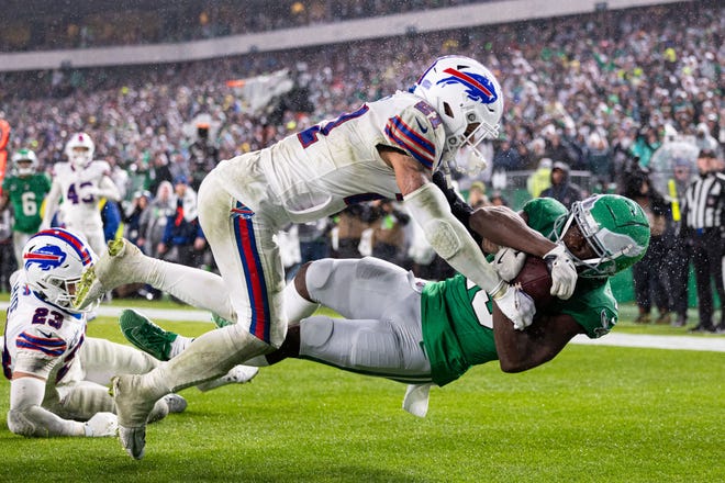 Nov 26, 2023; Philadelphia, Pennsylvania, USA; Philadelphia Eagles wide receiver Olamide Zaccheaus (13) makes a touchdown catch past Buffalo Bills safety Jordan Poyer (21) during the fourth quarter at Lincoln Financial Field. Mandatory Credit: Bill Streicher-USA TODAY Sports