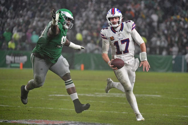 Nov 26, 2023; Philadelphia, Pennsylvania, USA; Buffalo Bills quarterback Josh Allen (17) scrambles away from Philadelphia Eagles defensive tackle Jordan Davis (90) during overtime at Lincoln Financial Field. Mandatory Credit: Eric Hartline-USA TODAY Sports