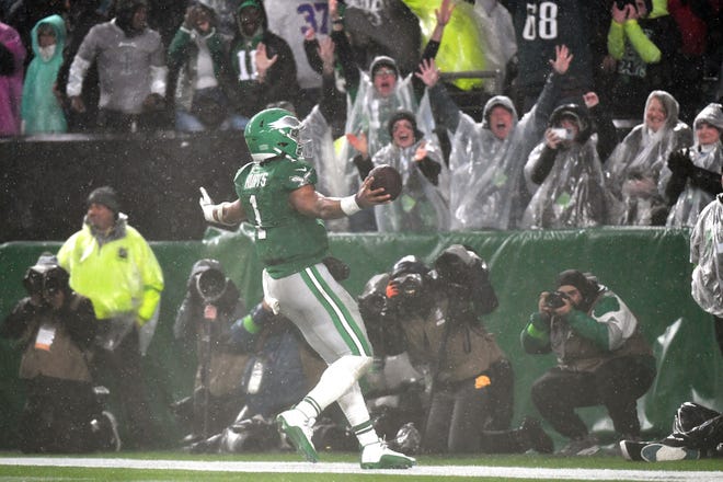 Nov 26, 2023; Philadelphia, Pennsylvania, USA; Philadelphia Eagles quarterback Jalen Hurts (1) scores the game-winning touchdown on a 12-yard run in overtime against the Buffalo Bills at Lincoln Financial Field. Mandatory Credit: Eric Hartline-USA TODAY Sports