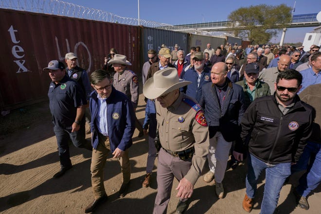 U.S. House Speaker Mike Johnson, center left, and Texas Department of Public Safety chief Steve McCraw, center right, lead a group of Republican members of Congress during a tour of the Texas-Mexico border, Wednesday, Jan. 3, 2024, in Eagle Pass, Texas. About 60 fellow Republicans in Congress are on a visit to the Mexican border. Their trip comes as they are demanding hard-line immigration policies in exchange for backing President Joe Biden's emergency wartime funding request for Ukraine.