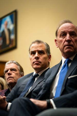 Hunter Biden, son of President Joe Biden, flanked by Kevin Morris, left, and Abbe Lowell, right, attend a House Oversight Committee meeting on January 10, 2024 in Washington, DC. The committee is meeting today as it considers citing him for Contempt of Congress.