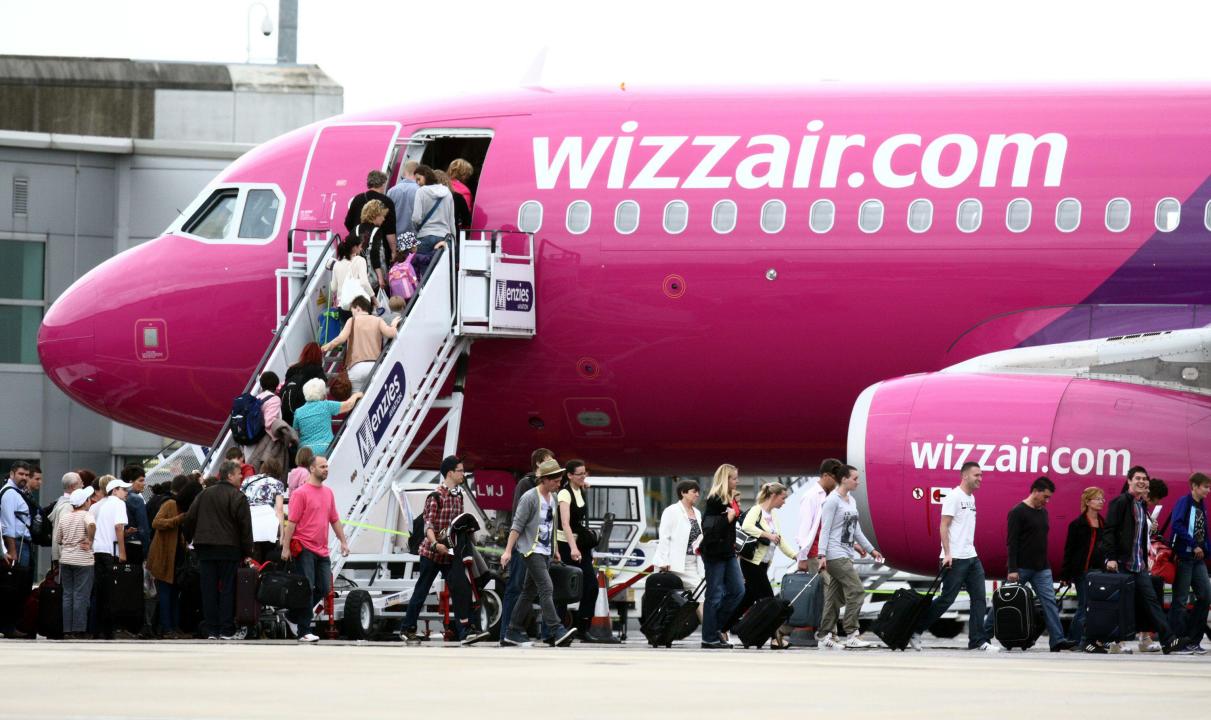 File photo dated 20/07/11 of passengers getting on a Wizz Air plane at Luton Airport. 