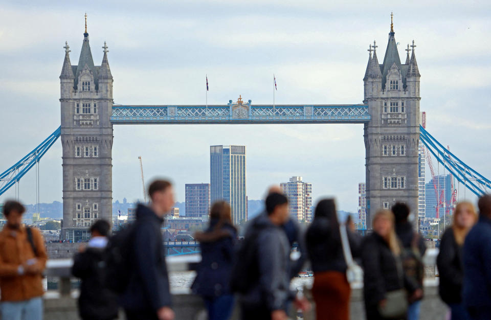 FTSE FILE PHOTO: People walk over London Bridge looking at a view of Tower Bridge in the City of London financial district in London, Britain, October 25, 2023. REUTERS/ Susannah Ireland/File Photo