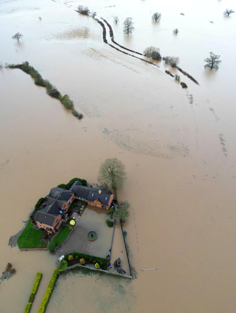 A house in the village of Severn Stoke is cut off amid flooding after heavy rain from Storm Henk, near Worcester, Britain, January 3, 2024 (REUTERS)