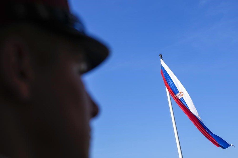 A member of the Serbian honor guard stands by a parliament building prior to a parliament constitutive session in Belgrade, Serbia, Tuesday, Feb. 6, 2024. Serbia's National Assembly held an inaugural session on Tuesday as ruling nationalists ignored widespread reports that parliamentary and municipal elections held in December were marred by vote rigging and other irregularities. (AP Photo/Darko Vojinovic)